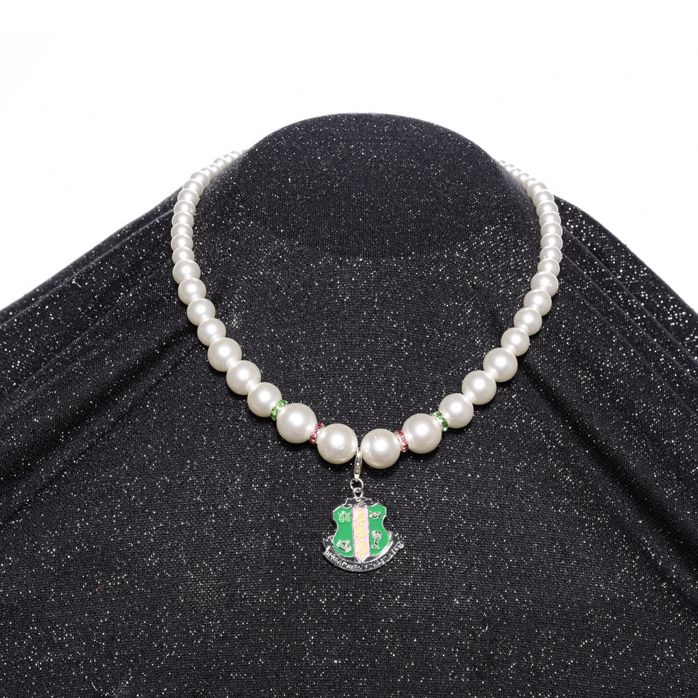 Single Strand Pearl Necklace w/ Crest Charm