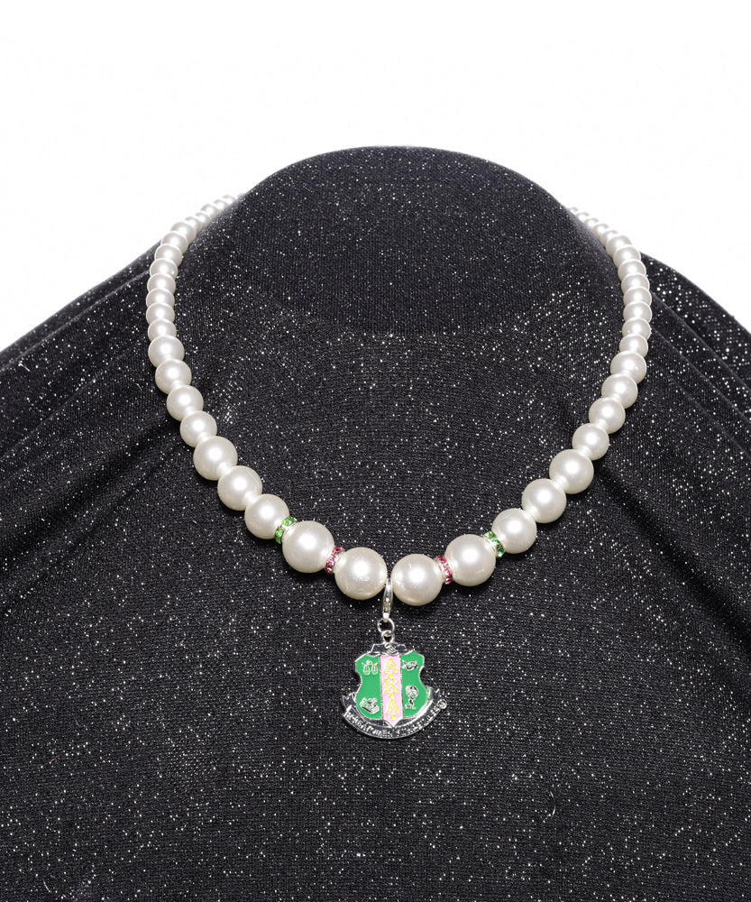 Single Strand Pearl Necklace w/ Crest Charm